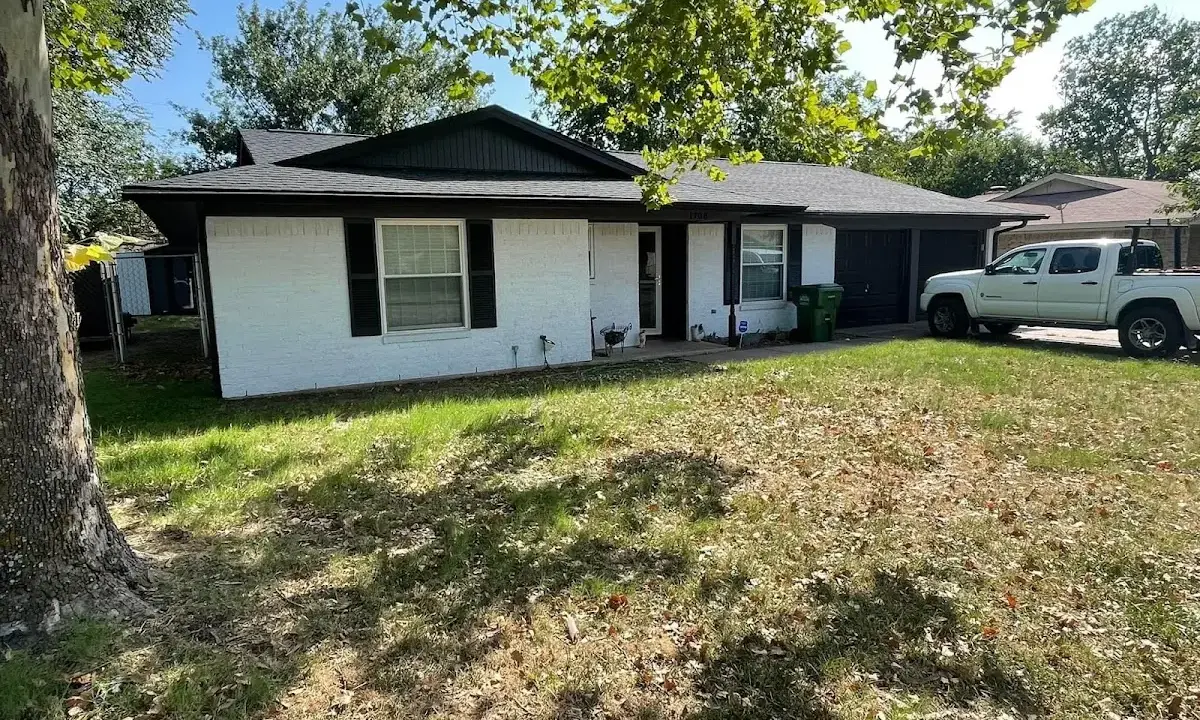 Professional roofing crew working on a residential roof in Eastmont